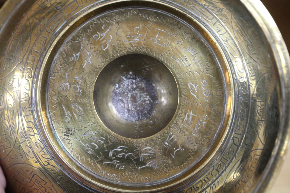 A large brass Persian magic bowl, Qajar dynasty, with inscribed decoration, diameter 21cm